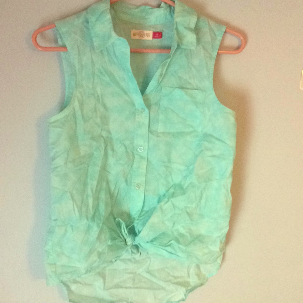 A blue sleeveless flannel top